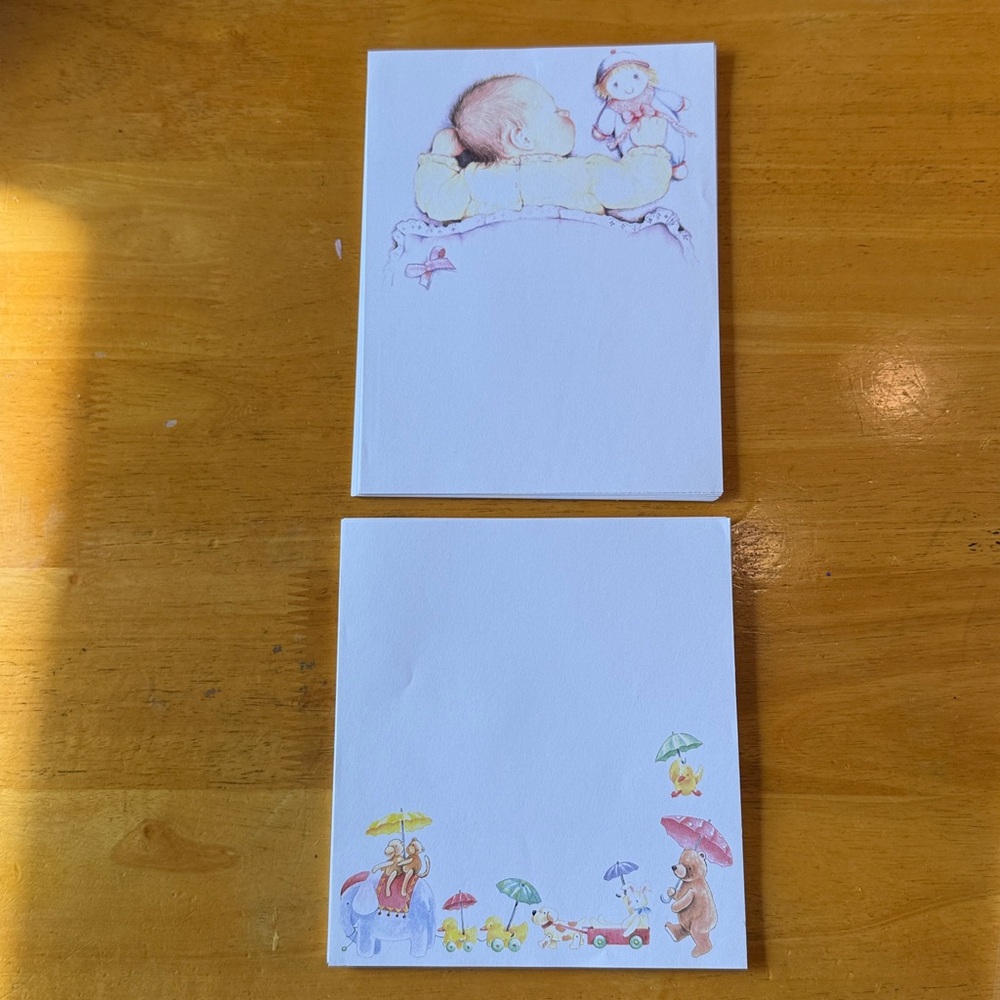 Assorted homemade stationary. 25 baby w/doll. 24 toys along bottom.
